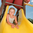 Happy childhood - little girl on the playground Happy childhood - little girl on the playground