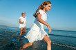 Happy summer - girl with mother playing on the beach