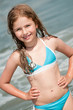Happy summer vacation - girl playing in the sea