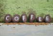 coffee on some pebbles and skilled wall background