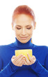 Portrait of a young redhead woman holding a yellow cup