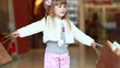 Child is spinning with the packages in the hands of