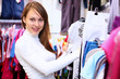 Young woman inside a store buying clothes