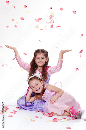 Photo: Two young princesses with flying petals Two young princesses with flying petals