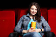 Young girl in cinema watching movie