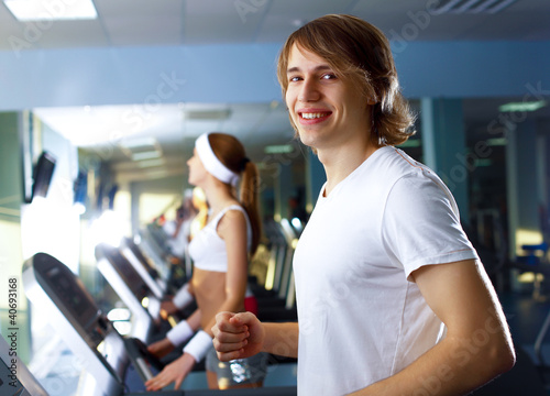 Photo: Young man doing sport in gym Young man doing sport in gym