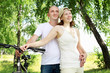Young couple on the bikes in the park