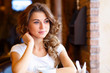 Young pretty woman sitting in restaurant