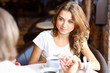 Young pretty woman sitting in restaurant