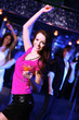 Young woman having fun at nightclub disco