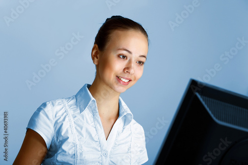 Photo: Young woman in business wear and headset Young woman in business wear and headset