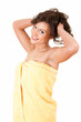 happy teenage girl with raised arms, in yellow towe
