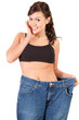 young woman in trousers showing how much weight she lost