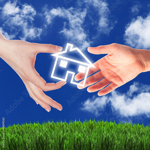 Illustration: House and human hand against blue sky House and human hand against blue sky
