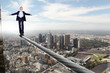 Business man balancing on the rope
