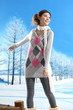 Winter fashion girl with scarf posing in winter park