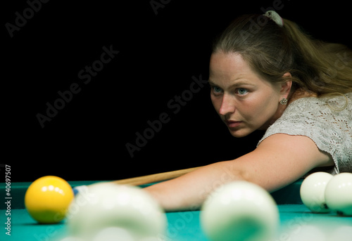 Photo: Woman aiming for billiard table Woman aiming for billiard table