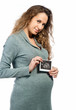 Pregnant woman holding ultrasound picture