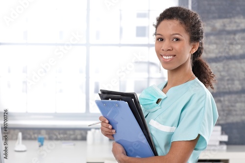 Photo: Happy medical worker with case sheets Happy medical worker with case sheets