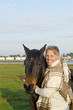 A blond man with his brown horse. A blond man with his brown horse.