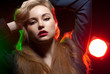 Photo: Beautiful girl posing in front of colored creative lighting Beautiful girl posing in front of colored creative lighting