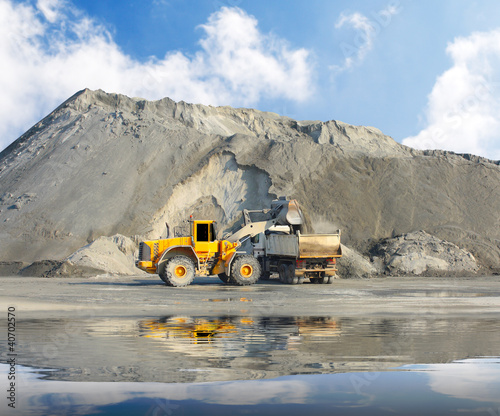 Photo: Big excavator and truck in mine. Big excavator and truck in mine.