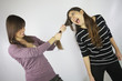 Photo: Girl pulling the hair to another girl that shouts Girl pulling the hair to another girl that shouts