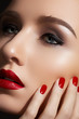 Fashion model with red lips make-up, bright nail polish
