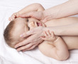 mother's hands trying to soothe angry baby