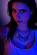 Beautiful girl posing in front of colored creative lighting Beautiful girl posing in front of colored creative lighting