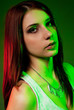 Beautiful girl posing in front of colored creative lighting Beautiful girl posing in front of colored creative lighting
