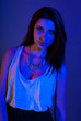 Beautiful girl posing in front of colored creative lighting Beautiful girl posing in front of colored creative lighting