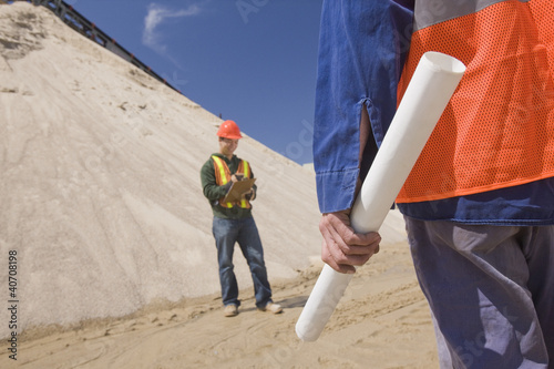 Photo: Two engineers at a gravel and asphalt plant Two engineers at a gravel and asphalt plant