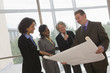 Photo: Business executives discussing a blueprint Business executives discussing a blueprint