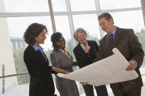 Photo: Business executives discussing a blueprint Business executives discussing a blueprint