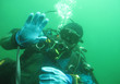 Scuba diver in freshwater. Diving in cold depth lake.