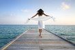 Sexy happy woman in white clothes standing on a jetty (Maldives) Sexy happy woman in white clothes standing on a jetty (Maldives)