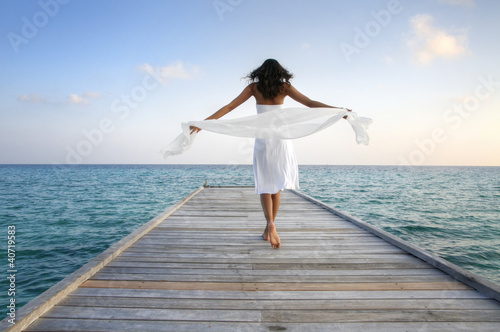 Foto: Sexy happy woman in white clothes standing on a jetty (Maldives) Sexy happy woman in white clothes standing on a jetty (Maldives)