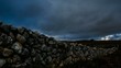 Wall made of rocks on a rural scene with wind turbines Wall made of rocks on a rural scene with wind turbines