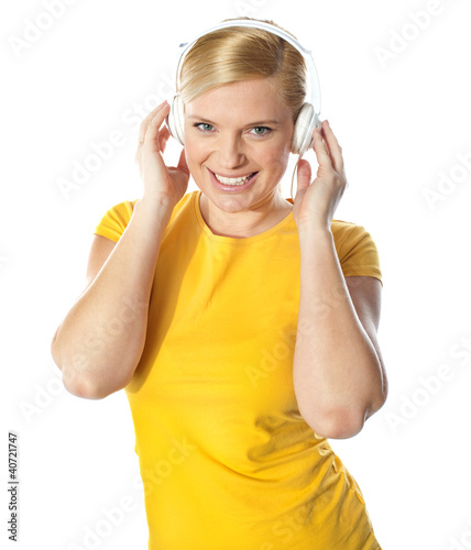 Photo: Smiling young lady listening music Smiling young lady listening music