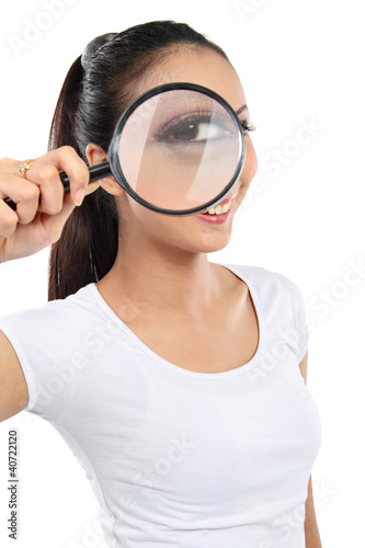 Photo: woman looking through a magnifying glass woman looking through a magnifying glass