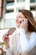 Young woman eating chocolate on the phone Young woman eating chocolate on the phone