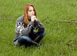 Young fashion girl sitting at green spring grass. Young fashion girl sitting at green spring grass.