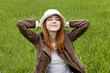 Young fashion girl in whte hat at green spring grass. Young fashion girl in whte hat at green spring grass.