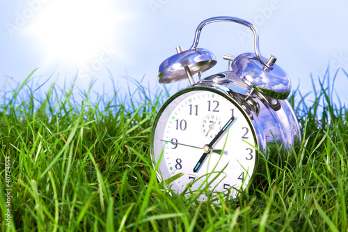 Photo: Morning alarm clock on grass Morning alarm clock on grass