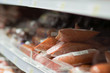 Variety of sausages delicatessen on shelves in supermarket