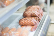 Variety of sausages on shelves in supermarket