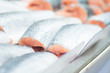Fresh cold fish lie on ice in supermarket