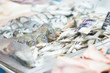 Fresh cold fish lie on ice in supermarket