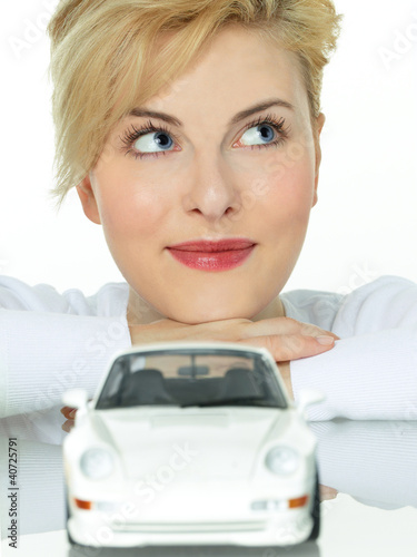Photo: Pretty woman is dreaming of a new car Pretty woman is dreaming of a new car